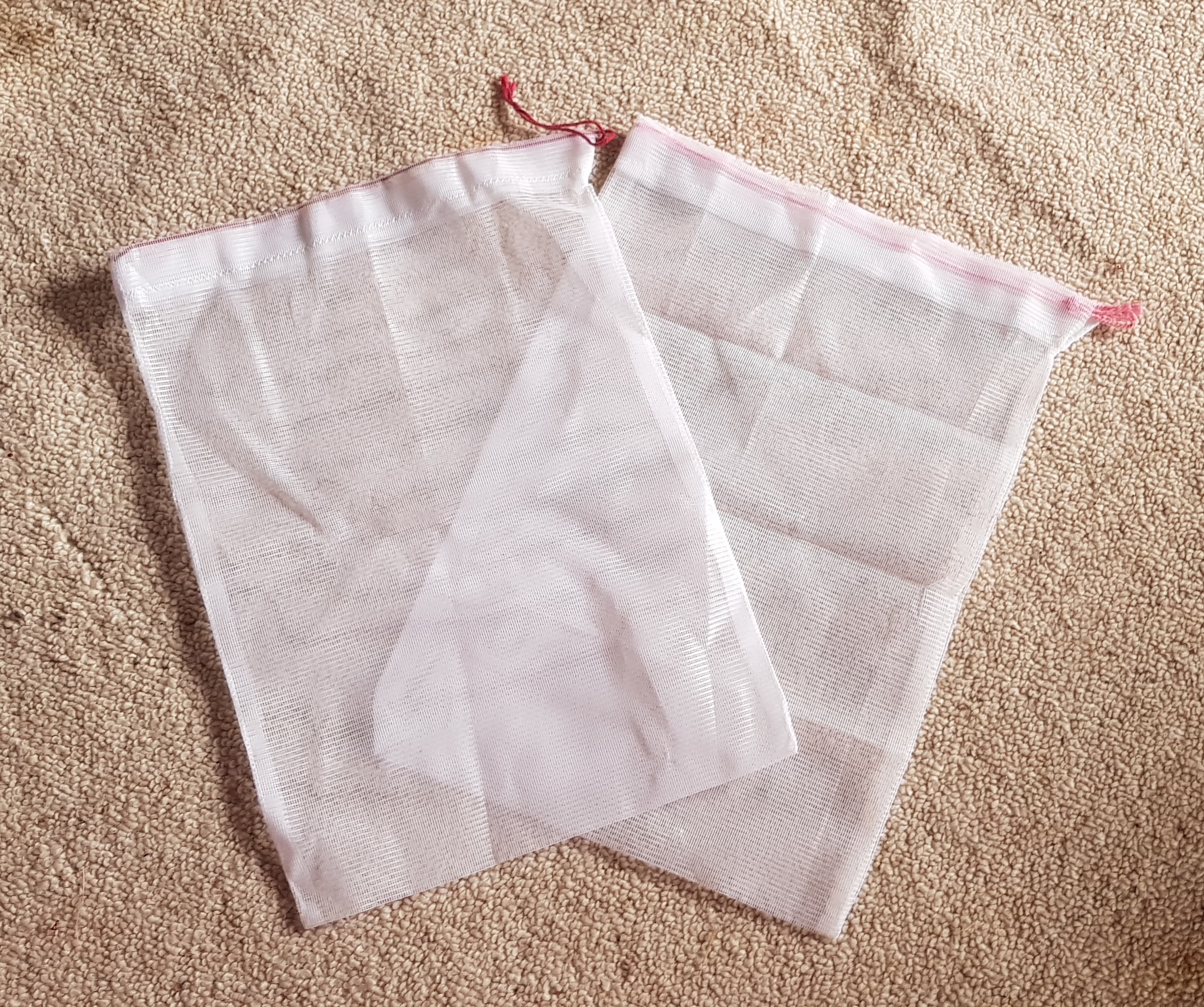 image of two white drawstring bags.